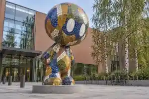 Mosaic cartoon abstract character sculpture on a Helsinki design school forecourt