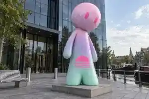 Three-quarter view of a 3.0 m cartoon abstract character airbrushed in pastel mint, lilac and pink