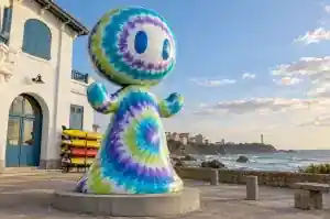 Tie dye cartoon abstract character sculpture outside a Biarritz surf lifesaving club