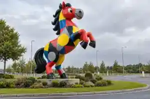 5 m cartoon horse sculpture rearing on a landscaped roundabout island near Milton Keynes