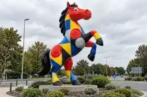 Three-quarter view of the colour-blocked painted fibreglass horse showing the hard-edged Bauhaus shapes