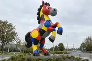 Detail of the cartoon horse's head and neck showing the flat red yellow blue and grey colour blocks