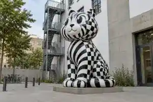 Op art cartoon tabby cat sculpture in fibreglass in a Berlin gallery courtyard