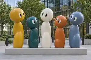 Detail of the rounded head of a deep teal cartoon abstract character sculpture