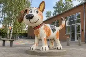 Detail of the uneven crayon-style colour fill on the head of a schoolyard dog sculpture