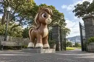 Three-quarter view of a cartoon pony fibreglass sculpture with a stylised mane, Wellington