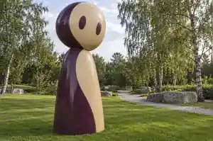 Three-quarter view of a 3.2 m cartoon abstract character with an oversized rounded head