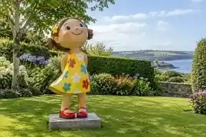 Large cartoon child figure in gloss-painted fibreglass in a County Cork garden