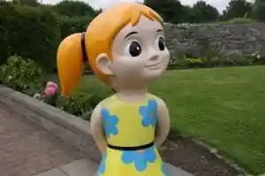 Detail of the painted face of a cartoon child fibreglass sculpture