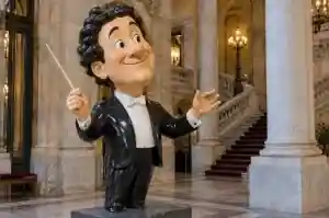 Detail of the painted face of a cartoon conductor portrait sculpture
