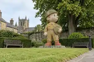 Weathered fresco-finished cartoon veteran sculpture in a Hexham town memorial garden
