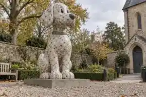 Three-quarter view of the terrazzo-finish painted fibreglass dog showing the chip pattern across the chest